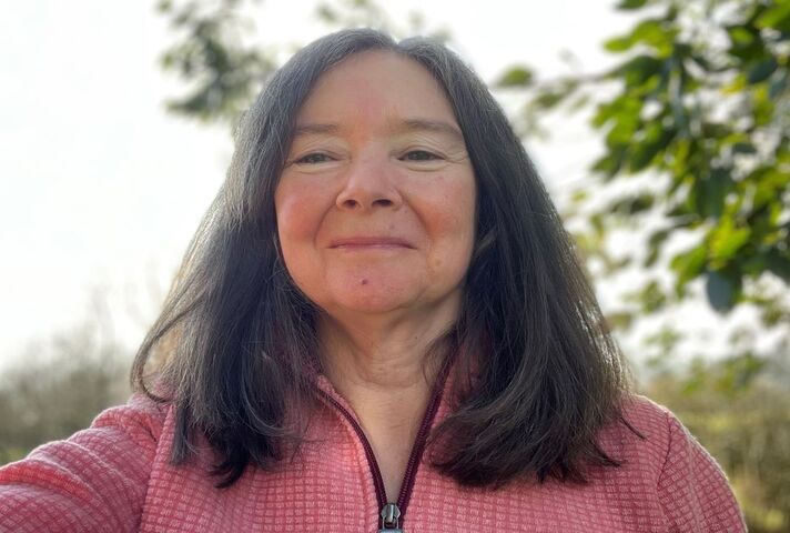 Image of Dr Sally Robinson: a woman with mid-length dark hair smiling